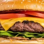 juicy homemade burger with melted cheese lettuce tomato on toasted bun