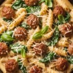 Creamy sausage pasta with Italian sausage, spinach, and Parmesan served in a skillet