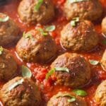 Italian beef and pork meatballs simmered in marinara sauce, tender and golden in a skillet
