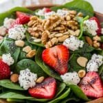Fresh strawberry spinach salad with goat cheese, nuts, and poppy seed dressing