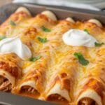 Creamy chipotle chicken enchiladas baked with sauce and melted cheese