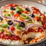 High-protein cottage cheese pizza bowl with marinara, melted mozzarella, and vegetables in a bowl