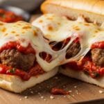 Easy cheesy meatball sub with marinara sauce melted mozzarella and toasted roll