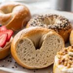 High-protein Greek yogurt bagels baked golden and served on a tray with toppings