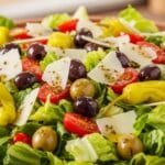 Big classic Italian salad with romaine lettuce, tomatoes, olives, pepperoncini, parmesan, and homemade Italian dressing