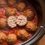 juicy crockpot meatballs simmered in marinara sauce inside slow cooker