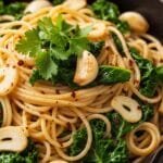 Spaghetti aglio e olio with sautéed kale and garlic in skillet
