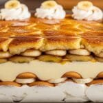 Caramelized banana pudding layered with vanilla pudding, vanilla wafers, and whipped cream in a baking dish