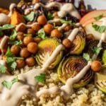 Harvest Quinoa Bowl with Creamy Tahini Dressing Harvest quinoa bowl with roasted sweet potatoes, Brussels sprouts, apples, chickpeas, and creamy tahini dressing served warm