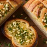 Homemade garlic bread baked until crispy on the edges with a buttery garlic and parsley topping on a crusty loaf