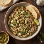 Slow cooker salsa verde chicken used as a filling for soft tacos.