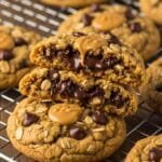 Thick peanut butter oatmeal chocolate chip cookies with chewy centers and crisp edges on a cooling rack