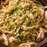 Effortless Salsa Verde Chicken (Slow Cooker) Shredded slow cooker salsa verde chicken coated in green salsa inside a crockpot
