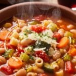Italian minestrone soup with vegetables, beans, and pasta in a bowl
