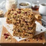 Easy no-bake granola bars made with oats, honey, and nuts sliced into bars on a wooden board