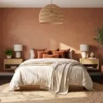 15 Terracotta Bedroom Ideas for a Warm and Cozy Space Terracotta bedroom ideas with warm earthy decor, cream bedding, natural wood furniture, and cozy styling