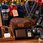 Thoughtful Christmas gifts for dad from daughter arranged on a festive wooden table, featuring a personalized father-daughter photo frame, engraved travel tumbler, cozy robe, leather toiletry bag, smartwatch, wireless earbuds, headphones, grilling tool set, wallet, books, and a personalized coffee mug surrounded by Christmas greenery, pinecones, ornaments, and wrapped presents.